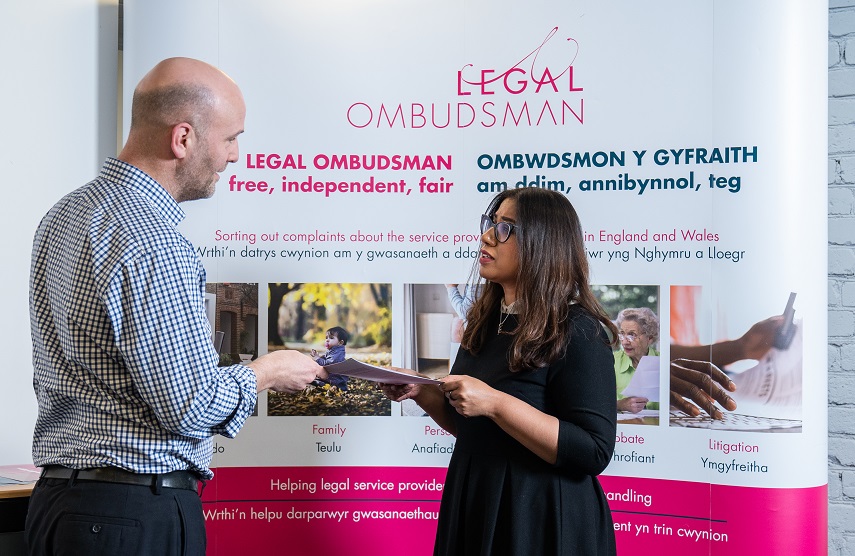 man and woman talking by Legal Ombudsman banner