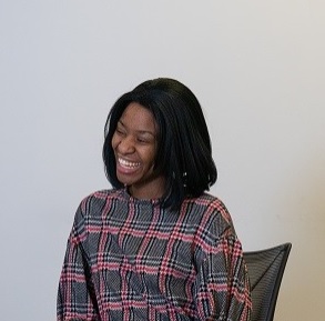 image of a woman smiling whilst seated